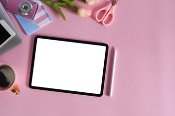Top view mockup digital tablet on pink office desk.