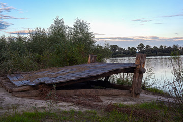 Old ferry crossing on the river in the evening