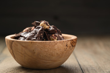 homemade dark chocolate with hazelnuts in wood bowl