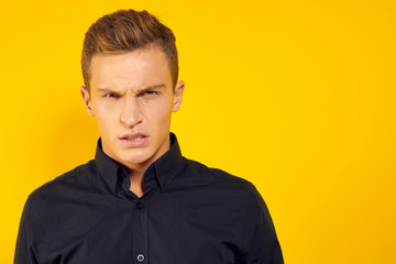 emotional man in black shirt lifestyle yellow isolated background