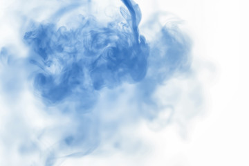 Puffs of paint in water. The dissolution of the dye in water. Water pollution. Concept art creativity.