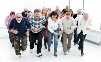 a group of pensioners are preparing to run forward