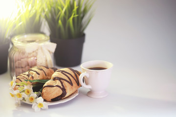 French breakfast on the table. Coffee croissant with chocolate and a decanter with cream. Fresh...