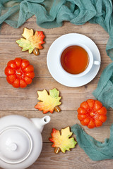 Homemade gingerbread cookies in the form of colorful autumn maple leaves on wooden background, top view