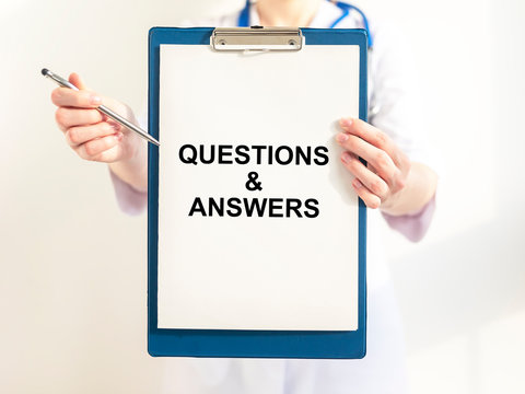 Q and A text word inscription acronym on paperin hands of doctor. medical questions and answers concept