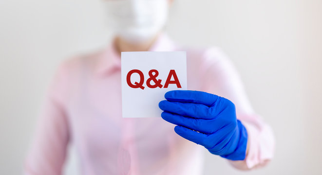 Q and A text word inscription acronym on paperin hands of doctor. medical questions and answers concept
