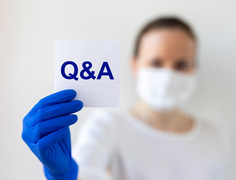 Q and A text word inscription acronym on paperin hands of doctor. medical questions and answers concept
