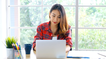 Work from home, Asian woman working with laptop computer at home, Asia female shopping online, Happy girl learning by internet, study online education, e commerce business