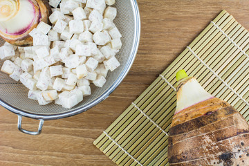 Taro root on wooden background./ Colocasia esculenta  on wooden background.