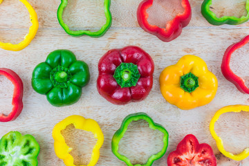 Sweet pepper on a wooden background./ Three colorful fresh yellow, red, green sweet pepper.