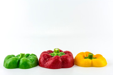 Sweet pepper on a white background./ Three colorful fresh yellow, red, green sweet pepper.