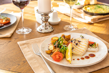 fried squid with grilled vegetables on a served table. served table with dishes.