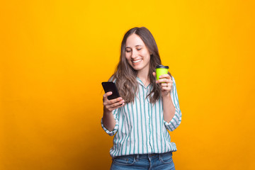 Photo of young happy woman using tablet and drinking cup of coffee.