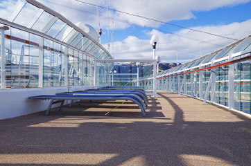 Outdoor Sun deck with deck chairs, sun loungers on modern Norwegian cruiseship or cruise ship liner