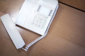 Fototapeta na wymiar Classic telephone on top of the table in a hotel room