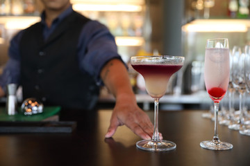 cocktails in glasses on bar counter in pup or restaurant