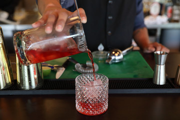 cocktails in glasses on bar counter in pup or restaurant