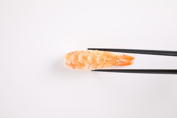 Shrimp sushi with chopsticks Japanese food isolated in white background