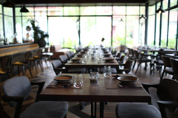 Table set with silverware dish and glass in restaurant