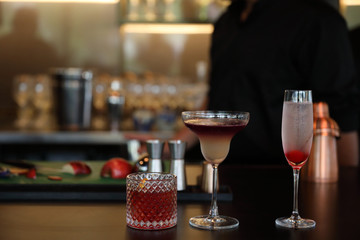 cocktails in glasses on bar counter in pup or restaurant