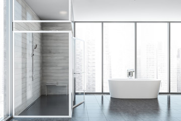 Fototapeta na wymiar Bathtub and shower in white wooden bathroom