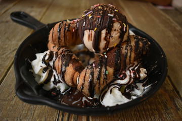 Tequeños with hazelnut cream, cream and vanilla ice cream, served as dessert.