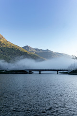 The fog surrounding the bridge on the lake of Silvaplana in the Engadin valley at sunrise
