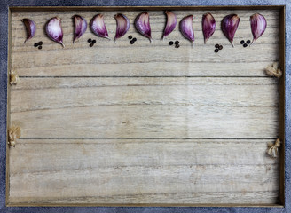 garlic and black pepper on wooden texture