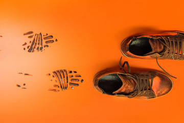 Shoes leaving black marks on an orange background