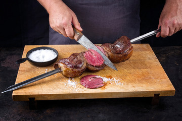 Traditional barbecue dry aged wagyu Brazilian picanha from the sirloin cap of rump beef sliced by a...