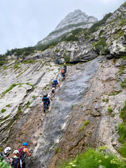 Fototapeta premium Man Hiking to the top of Germany with a stunning view to the alpine rocks in Germany