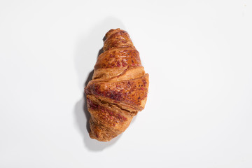 Fresh baked croissant on white background