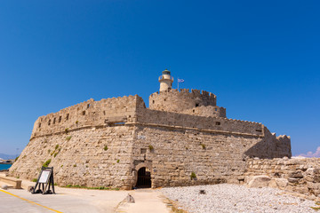 Fototapeta na wymiar The fort of St. Nicholas in Mandrakia port of Rhodes. Greece