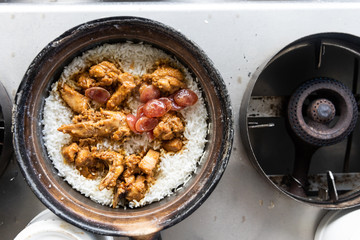 Delicious clay pot chicken rice being prepared in restaurant. Popular delicacy in Malaysia