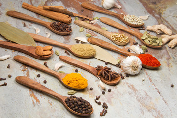 Aromatic spices on wooden spoons. Food ingradients.


