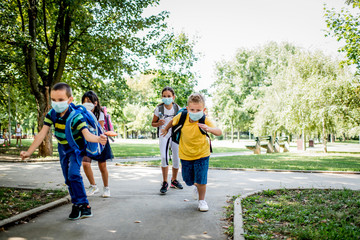 Fototapeta premium Children going back to school after epidemic, They are wearing a protective face mask