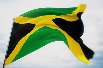 Waving flags of the world - flag of Jamaica. Shot with a shallow depth of field, selective focus. 3D illustration.