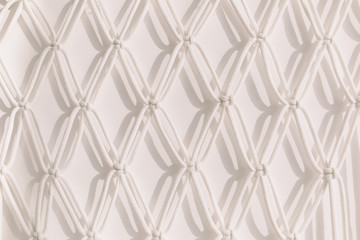 Macrame pattern, atmospheric shadows on the wall.