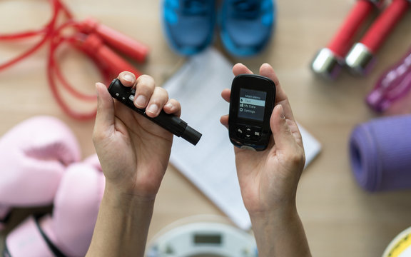 Diabetes monitoring with blood sugar test, glocuse measurement for diabetic disease awareness and control for analyzing insulin-deficient illness patient with exercise sport equipment background