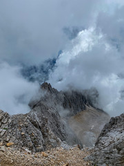 Man Hiking to the top of Germany with a stunning view to the alpine rocks in Germany