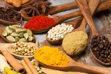 Aromatic spices on wooden spoons. Food ingradients.



