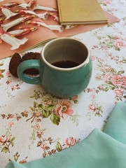 Cup of coffee and vintage journal 