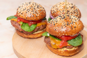 fresh tasty burger on a wooden table. Food with vivid colors