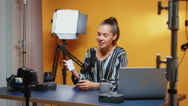 Social media influencer doing a mini Led light review in professional studio. Video blogger recording a vlog with technology product equipment use in videography and photography
