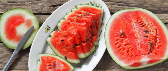 Food background. Sliced red watermelon on a wooden table.