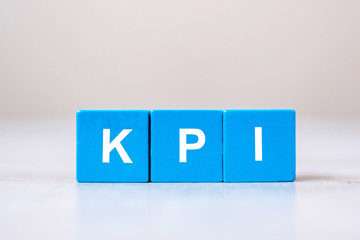 wooden cube block with KPI (KEY, Performance and Indicator) word on table background. Business concept