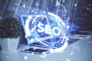 Multi exposure of table with computer and seo drawing hologram. Search optimization concept.