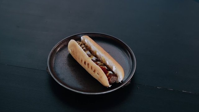Crop frame with burger on a ceramic tray. appetizing burger with a flattened shape