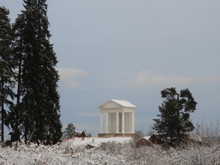 White gazebo in classical style located on the shores of the Gulf of Finland in Mon Repos Park