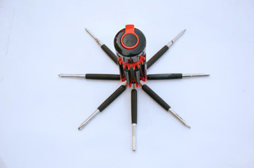 the old black red screw driver isolated on white background.